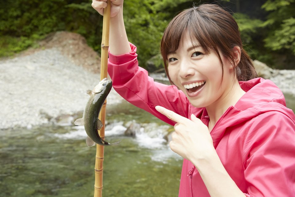 女性　釣り竿　魚　川　写真