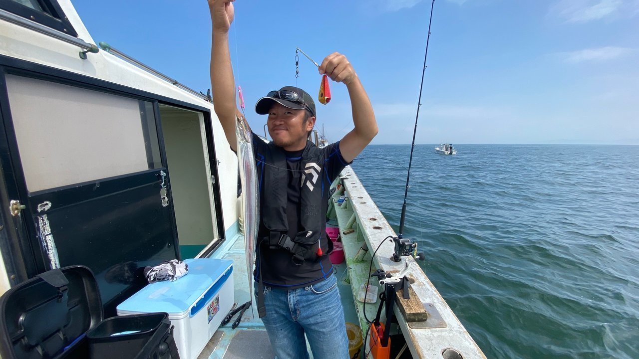 釣り人とスルメイカの写真